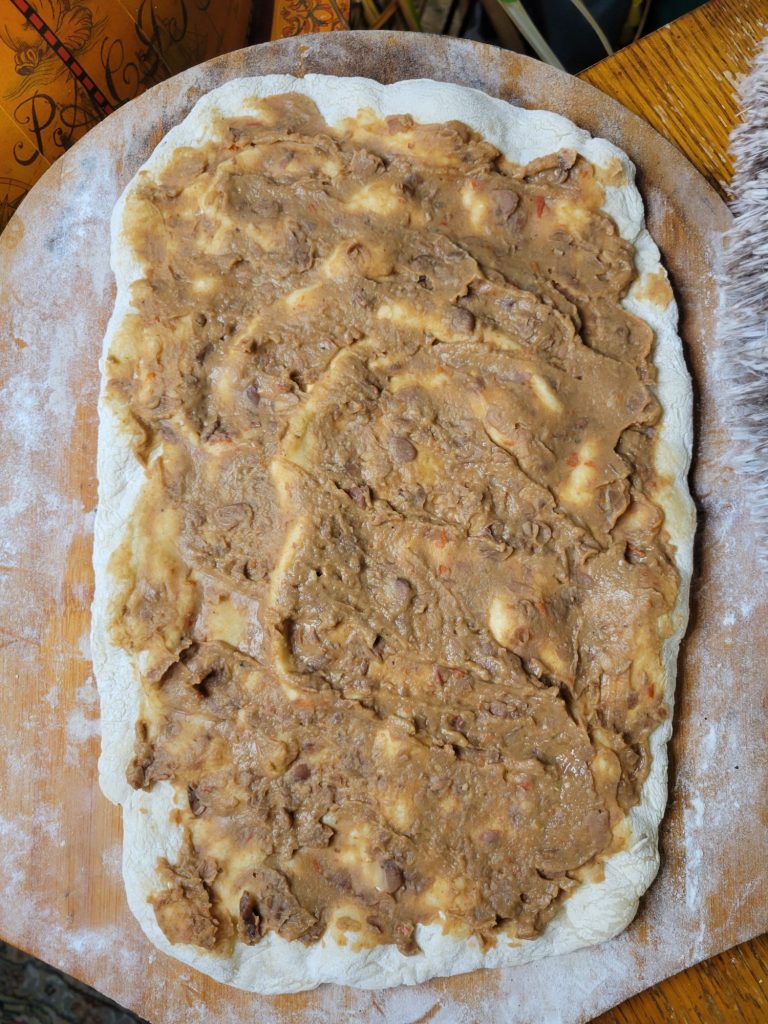 Pizza w/ Refried Beans, Wild Rice, Apples, & Crema